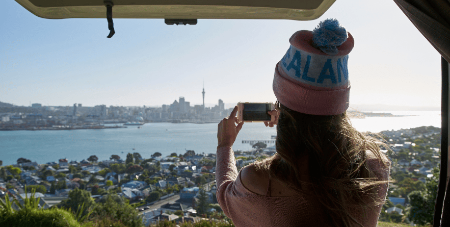 Person taking a photo of Auckland cityscape