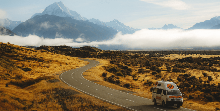 Campervan on road with Mount Cook in background