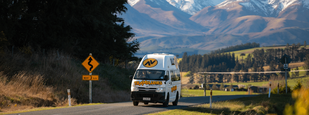 Campervan driving on road in South Island, New Zealand 